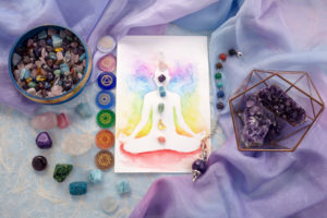 Natural crystals and pendulum on pastel silk background. Reiki